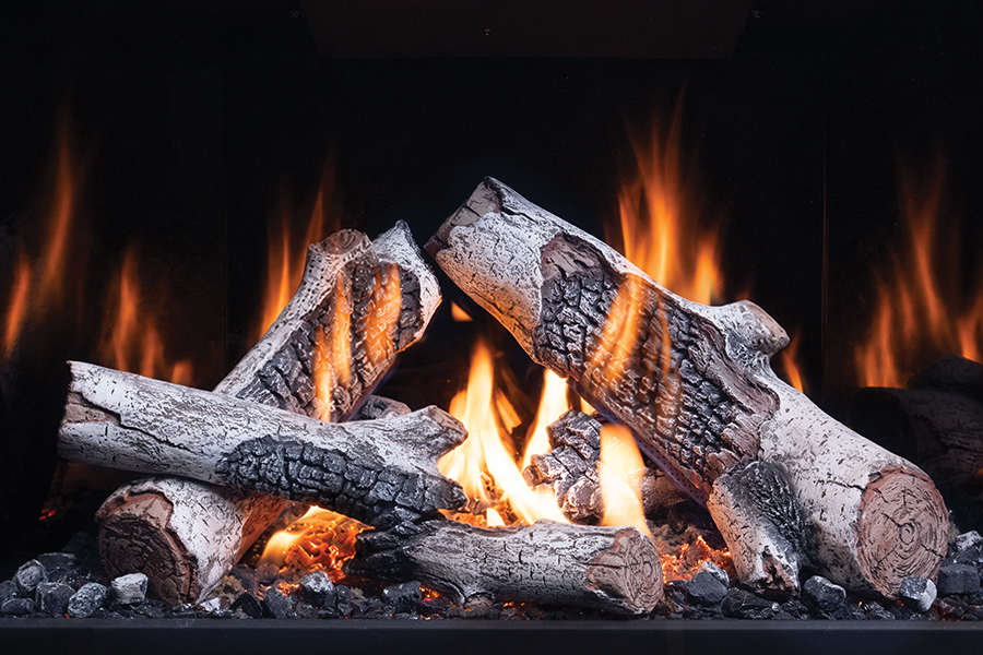 A cozy fireplace with burning logs and glowing embers.
