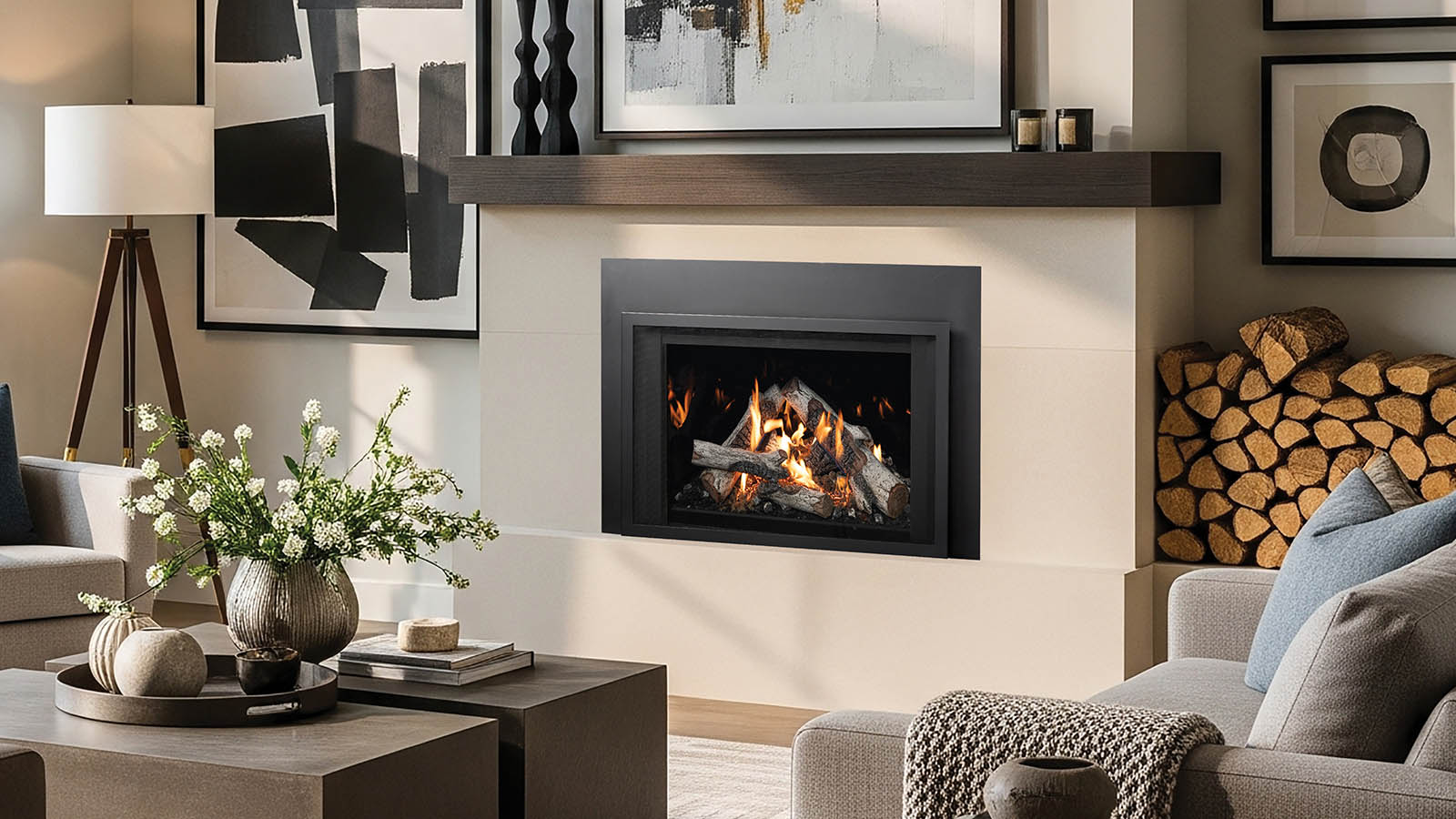 Cozy modern living room with a fireplace, abstract art, and a stack of firewood nearby.