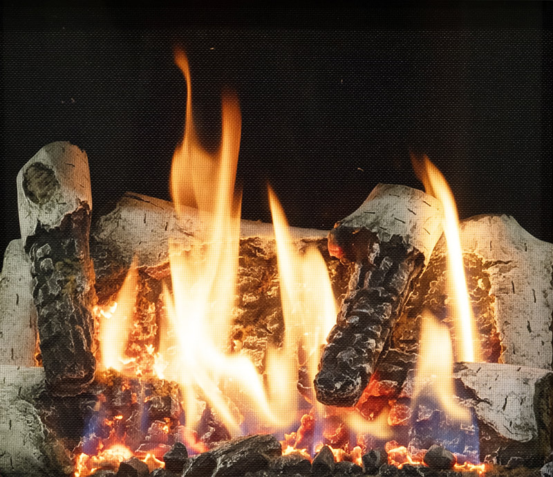 Fireplace with burning logs and bright flames, warm embers glowing in a hearth.