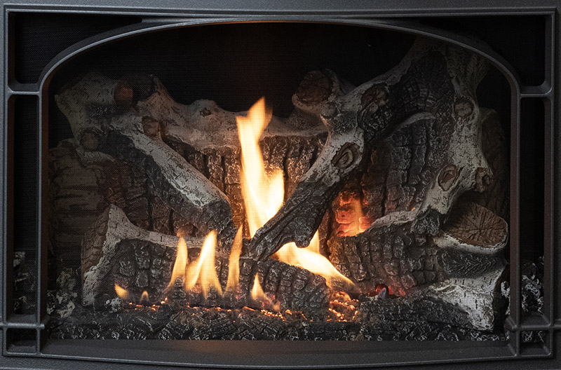 Wood-burning fireplace insert with glowing embers and flickering orange flames.